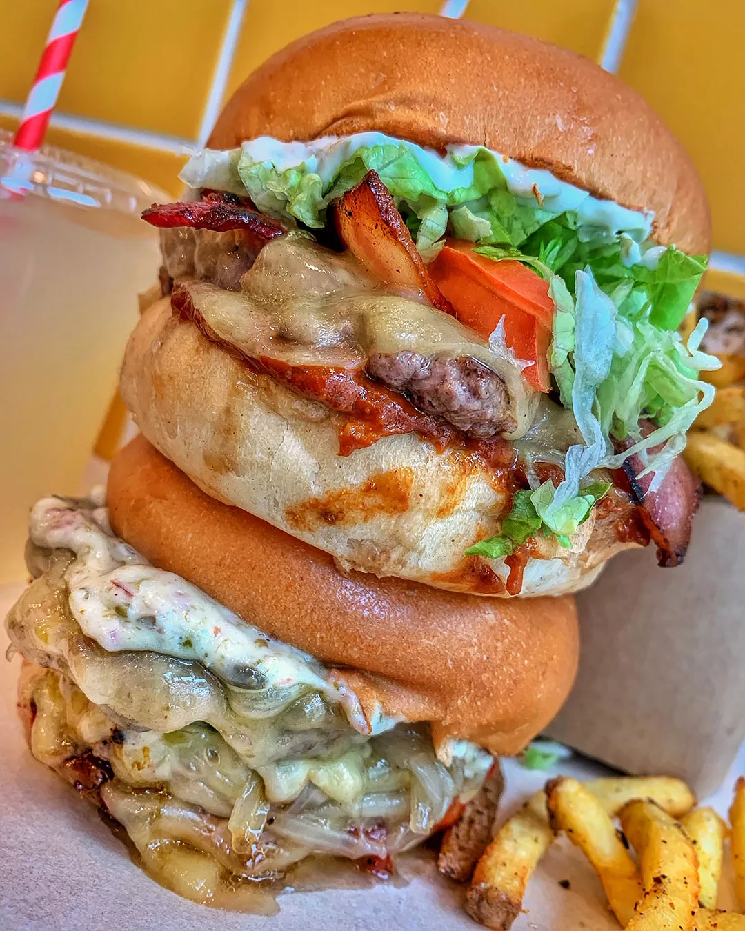 A stacked Squeezed burger with fries
