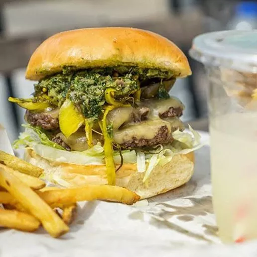 A Squeezed burger with fries and lemonade